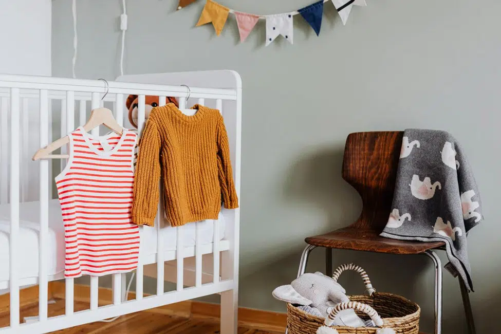 “Assorted baby clothes for boys including onesies, jackets, and rompers in soft, comfortable fabrics”