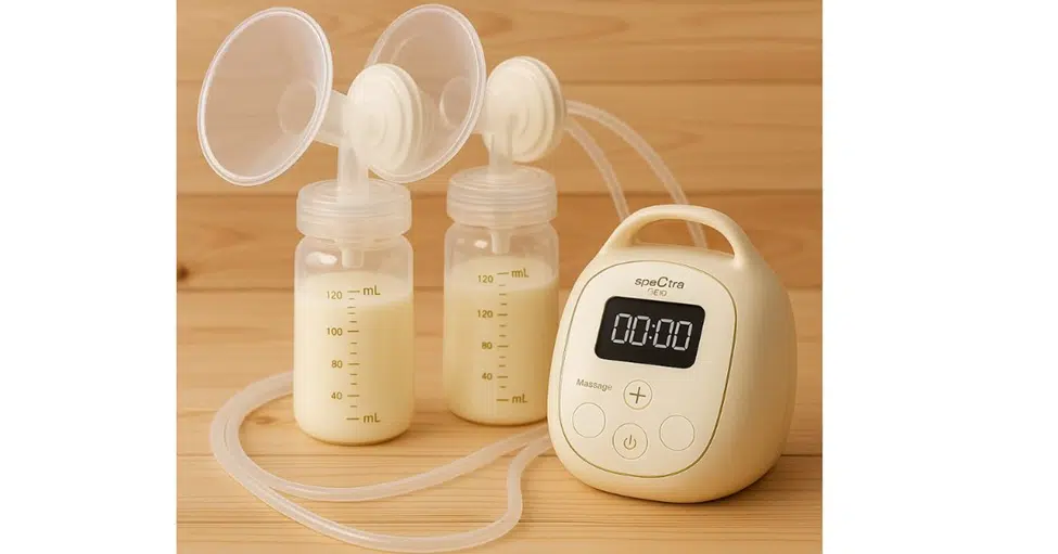 Spectra breast pump parts including flanges, bottles, valves, and tubing on a clean white background