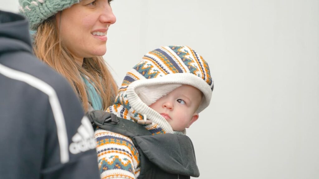 Plus size parent adjusting baby wrap carrier for comfort