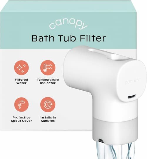 A sleek white Canopy baby bath tub filter attached directly to a metal faucet spout, showcasing its protective silicone cover design.