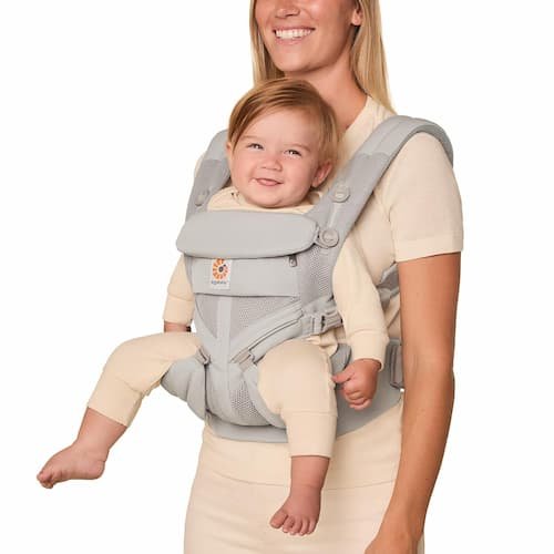 Ergobaby Omni Classic baby carrier in pearl grey mesh worn by a mother in an ergonomic front carry setup.